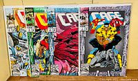 Four Marvel comic books from 1992 featuring 'Cage', including three parts of 'The Evil and the Cure' series and 'A Hero for Hire Who's Working Overtime'. Comics are in plastic bags with backing boards.