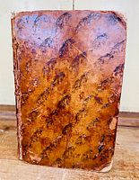 Front cover full view showing marbled leather binding pattern and wear