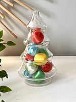 Front view of vintage glass Christmas tree filled with colorful silk ornaments, showing the design and colors clearly.