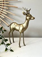 Front-right angled view of vintage brass deer figurine highlighting form, detailing, and patina.