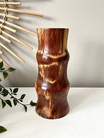 Front view of the handmade wooden vase showing smooth polished surface and natural wood grain.