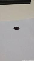 Top and side view of the natural deep red pyrope garnet gemstone on white background.