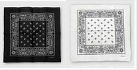 Two bandannas laid flat showing one black with white paisley print and one white with black paisley print, displaying pattern and colors