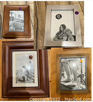 Three picture frames arranged together on wooden surface: one small warm brown wooden frame 4x6, one larger darker brown wooden frame, one metallic 5x7 frame.