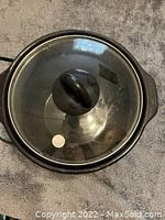 Top view of the Crock-Pot showing glass lid with black handle knob.