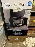 Box of Mainstays 32 inch TV stand showing product details and assembly information.