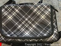 Closed thermal dish bag with plaid pattern exterior in gray and black tones.