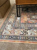 Close-up photo showing the corner and border details of the Belgium made 5x7 area rug with geometric design and multiple colors