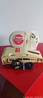 Photo of Dr. Ho De-Stress Belt compression support belt in beige with an included controller and cable for electric therapy.
