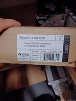 Label on box showing model FMDHL 14 20830 BN, Denon 14" LED flush mount, brushed nickel, 3000K.