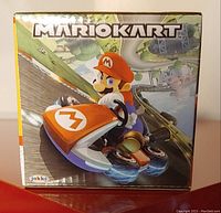 Box front showing Mario Kart Mario racer vehicle with racing track background artwork