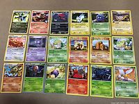 Overview of 18 rare Pokemon cards with names and attacks visible.