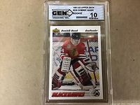 Photo of graded Dominik Hasek rookie card from 1991-92 Upper Deck, showing front of card and grading label