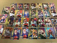 Overview photo showing all 31 rookie hockey autograph cards arranged in rows showing signatures and numbering.