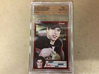 Front of Sidney Crosby hockey card graded Gem Mint 10 by SPA, showing image of young Crosby with medal and player information.