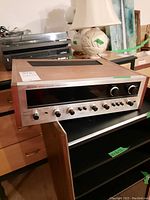 Overall front view of Pioneer SX-990 on shelving, wood veneer sides visible