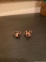 Two rings front view side by side on dark surface