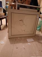 Framed Benjamin Chee Chee 1975 print showing stylized bird in natural tones, with visible sticker on glass.