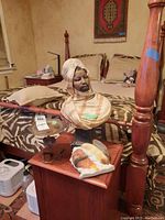 Full view of painted bust on metal snake base