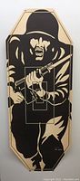 Full view of the original WWII paper target showing an enemy soldier holding a rifle with bayonet in black silhouette printed on tan paper with an octagonal shape and mounting holes in corners.