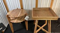 Photo showing both side tables, one circular two-tier and the other square tray-top with crossed base, highlighting their natural acacia wood finish.