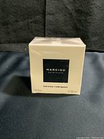 Front view of sealed cream box with black label showing product name and size