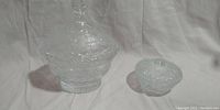 Full view of the crystal bowl with lid next to the smaller candy dish on a white background
