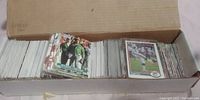 Box filled with a large collection of football cards neatly stacked in rows.