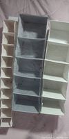 Front view of the 3 hanging cloth organizers showing compartment arrangement and material detail