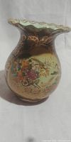 Front view of vase showing colorful floral and bird decorations with scalloped rim.