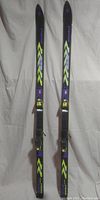 Full view of the pair of Völkl P9 cross-country skis standing vertically, showing bindings and overall design.