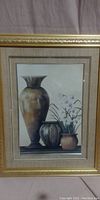 Full front view of the framed wall art showing three vases and flowers.