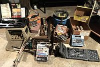 Full view of large assortment of power and hand tools including cases, boxes, and automotive accessories.