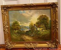 Frontal view of the framed lithograph showing the Hudson River landscape with surrounding trees, farmhouse and mountainous background. Ornate gold gesso frame visible with decorative corner adornments.
