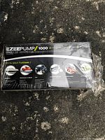 Photo of sealed Ezeepump 1000 manual pump and vise box showing front label with usage icons and branding.