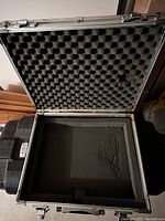 Interior view showing egg crate foam on lid and flat foam on base, both dirty and worn.