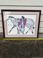 Full frontal image of the framed watercolor painting showing the person and horse.