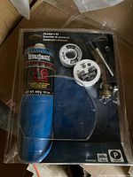 Photo of new Bernzomatic plumber's kit in original blister packaging showing propane fuel cylinder, torch head, hose, and regulator knob.