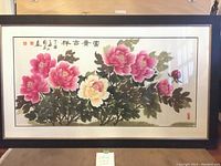 Full view of framed traditional Chinese watercolor painting featuring pink and yellow peonies, Chinese calligraphy, and artist's stamp.
