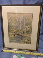 Framed watercolor painting showing the full artwork including frame, matting, and glass, dimensions visible with measuring tape.