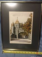 Framed serigraphy art showing the full frame and artwork with a measuring tape indicating frame width about 13 inches. Glass-covered piece with gray matting.
