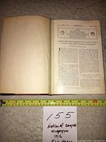 Photo of an open vintage National Geographic Magazine from March 1916 showing the title page 'Great Britain's Bread Upon The Waters, Canada and His Other Daughters' with a measuring tape showing size approx 13 inches wide