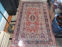 Full view of rectangular rug showing central medallion and border pattern.