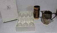 Boxed set of 6 JG Cristal Durand crystal glasses with the lustre vase and copper pitcher beside them.