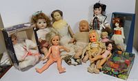 Lot of 12 vintage and collectible dolls displayed together showing types, sizes, and conditions.