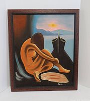 Front view of framed nude painting showing seated female figure and signature