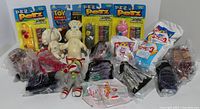 Full lot of sealed and unsealed collectible toys including Pez dispensers, McDonald's Happy Meal toys, Pillsbury Doughboy and Doughgirl, and Toy Story figures.