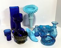 Overall lot of vintage blue and cobalt glass items including vases, shakers, boot figurine, and footed bowl.
