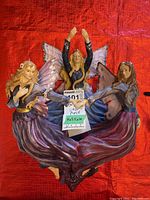 Top view of the composite wall sconce showing the three dancing fairy figures with wings and flowing dresses in purple and blue.