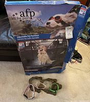 AFP Travel Dog Adjustable Pet Partition retail box with three dog collars in front.